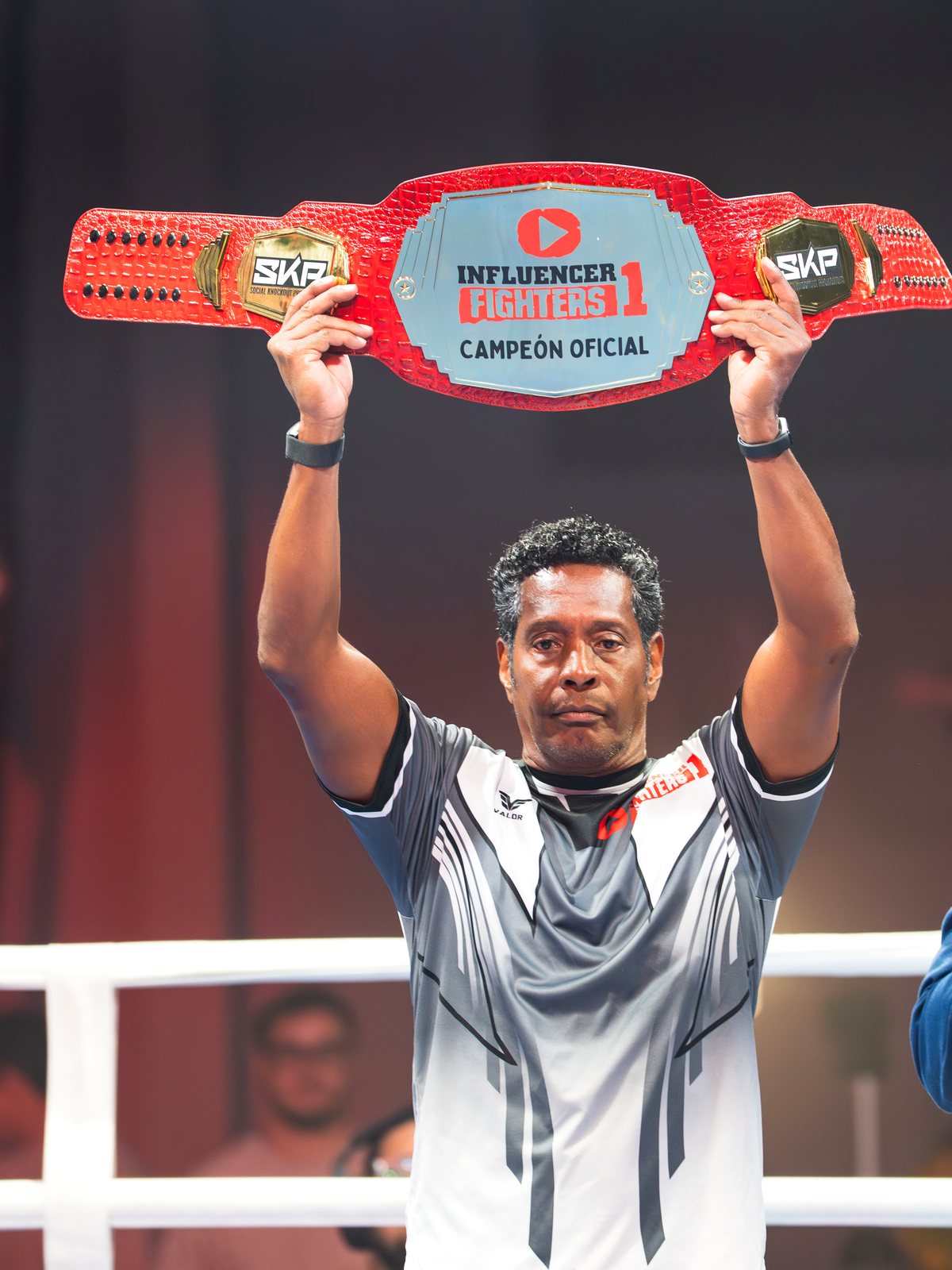 Campeón levantando el cinturón de Influencer Fighters